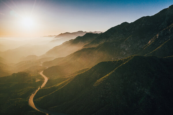 A road bends through the lower elevations of the San Gabriel Mountains.