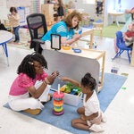 Michaela Frederick, a pre-K teacher in Sharon, Tenn., playing a stacking game with a student.