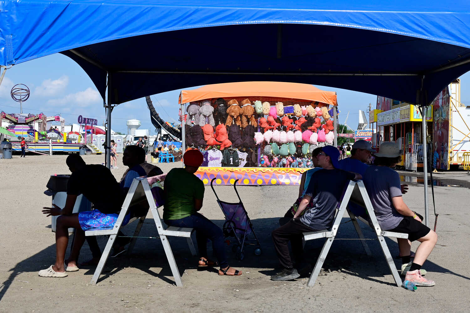 Fairgoers sitting in the shade at the Red River Valley Fair in West Fargo, N.D., on Saturday.