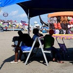 Fairgoers sitting in the shade at the Red River Valley Fair in West Fargo, N.D., on Saturday.