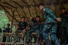 Ko Maung Saungkha, center, a poet who is a rebel commander in Myanmar, on the first day of training for new recruits in Karen State, in May.