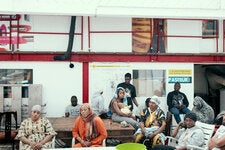 Immigrants sitting together inside the so-called Squat Gambetta in Seine-Saint-Denis, a suburban area east of Paris. 