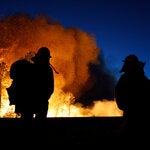 Firefighters watch as the Park Fire gets closer to highway 32 in Chico, Calif., on Thursday.