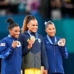 Jordan Chiles, right, with her teammate Simone Biles and Rebeca Andrade of Brazil after the floor exercise.