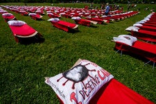 Cots placed outside the Washington Monument in 2023 to represent people suffering from long Covid and ME/CFS. A new study estimates 400 million people worldwide have had long Covid and says the global economic cost is $1 trillion a year.