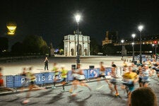 The Olympic cauldron glowed over runners in the Marathon for All.