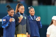 Jordan Chiles, right, with Simone Biles, left, and Rebeca Andrade after the floor exercise final last week in Paris.