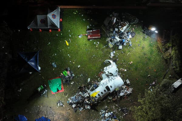 Debris from a plane crash on the ground, shown from an aerial view.