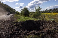 A Ukrainian military vehicle passing a roadside crater minutes after a Russian strike near the border in Ukraine’s Sumy region on Tuesday.