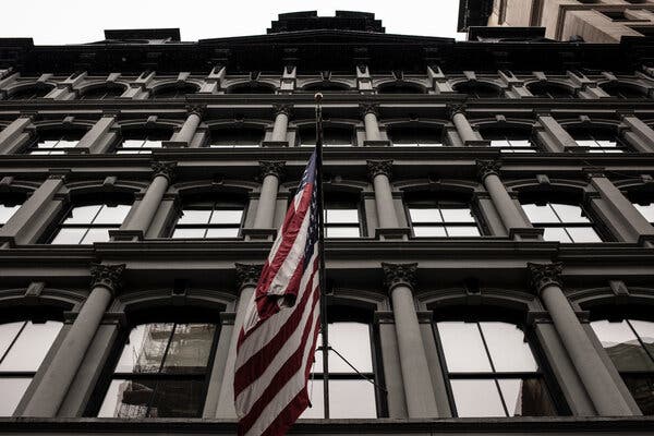 A large office building with an American flag.