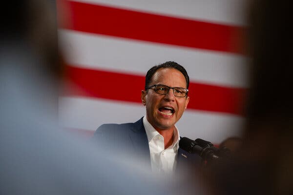 Governor Josh Shapiro speaking at a podium. 