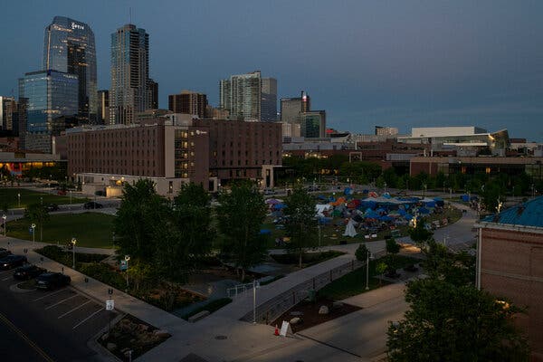 A distant view of a university campus in an urban setting at dusk.