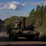 Ukrainian troops driving a tank along a main road in the Sumy region of Ukraine, near the Russian border, on Monday.