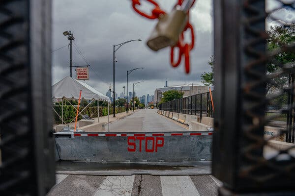 Fencing runs along a street.