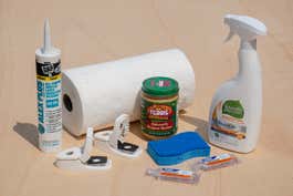 Caulk, paper towels, ant traps, and cleaning solution used to get rid of ants and bugs.