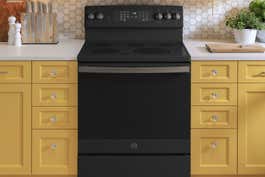 A black, slide-in electric range in a kitchen.