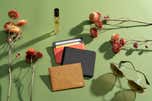 A selection of wallets tested for this review, shown on a green background with flowers.