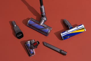 The Dyson V12 Detect Slim with four attachments and cleaner heads.