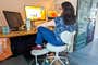 A person sitting in the Pipersong Meditation Chair at their desk.