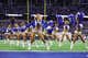 The Dallas Cowboys cheerleaders dancing on the field.