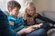 Two children looking at a tablet together.